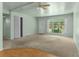 Spacious living room with large windows, a neutral color scheme and front door access at 3373 Olson Rd, Spring Hill, FL 34607