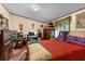 Comfortable primary bedroom with a red bedspread and work area at 3373 Olson Rd, Spring Hill, FL 34607