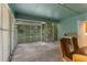 Enclosed patio with tile flooring and green painted wood, leading to outdoor space at 3373 Olson Rd, Spring Hill, FL 34607