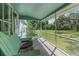 Relaxing screened-in porch with comfortable seating, offering a peaceful view of the surrounding yard and trees at 3373 Olson Rd, Spring Hill, FL 34607
