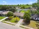 Aerial view of home with manicured lawn and mature palm trees in the front yard at 3628 Dellefield St, New Port Richey, FL 34655