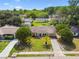 Aerial view of home with manicured lawn and mature palm trees in the front yard at 3628 Dellefield St, New Port Richey, FL 34655