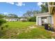 Open backyard with sliding glass door access and healthy grass and landscaping at 3628 Dellefield St, New Port Richey, FL 34655