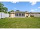 Well-maintained backyard features a screened lanai, a shed, and ample green space at 3628 Dellefield St, New Port Richey, FL 34655
