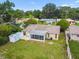 Backyard aerial view showcasing a covered lanai and a well-maintained lawn with shed at 3628 Dellefield St, New Port Richey, FL 34655