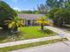 Charming home with well-manicured lawn and mature palm trees in the front yard at 3628 Dellefield St, New Port Richey, FL 34655