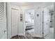 Hallway with a bedroom view, and bathroom across the hall, featuring plank flooring and fresh paint at 3628 Dellefield St, New Port Richey, FL 34655
