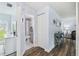 Inviting hallway featuring wood-look floors and views into the bathroom and living area at 3628 Dellefield St, New Port Richey, FL 34655
