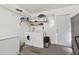 Laundry room with washer, dryer, storage shelves, and backyard access door at 3628 Dellefield St, New Port Richey, FL 34655
