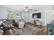 Bright living room features a large sectional, stylish rug, and access to the front door at 3628 Dellefield St, New Port Richey, FL 34655