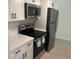 Modern kitchen with stainless steel appliances, white cabinets and quartz countertops for a sleek design at 3640 41St S Ln # F, St Petersburg, FL 33711