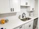 Modern kitchen featuring white cabinets, quartz countertops, stainless steel appliances, and ample storage space at 3640 41St S Ln # F, St Petersburg, FL 33711