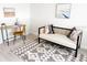 Sitting room with a stylish settee, desk, artwork, and a patterned rug at 3640 41St S Ln # F, St Petersburg, FL 33711