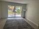 Bright living room with sliding glass doors, natural light, and neutral tones creating an inviting space at 3640 41St S Ln # F, St Petersburg, FL 33711