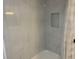 Tiled shower stall with a built-in shelf niche and a shower curtain at 3640 41St S Ln # F, St Petersburg, FL 33711