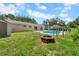 Backyard with pool, fire pit, green grass, and partial fence at 3641 Coppertree Cir, Brandon, FL 33511