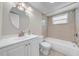 Well-lit bathroom featuring a vanity, toilet, and a shower-tub combo with tiled walls at 3641 Coppertree Cir, Brandon, FL 33511