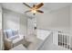 Cozy bedroom with ceiling fan, sitting area, and white storage dresser at 3641 Coppertree Cir, Brandon, FL 33511