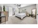 Bedroom with neutral carpet, ceiling fan, en suite bathroom, and natural lighting at 3641 Coppertree Cir, Brandon, FL 33511
