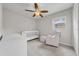 Bedroom with a crib, rocking chair, and a window with natural lighting at 3641 Coppertree Cir, Brandon, FL 33511