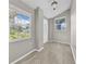 Bright foyer featuring tile flooring, natural light from large windows, and neutral wall paint at 3641 Coppertree Cir, Brandon, FL 33511