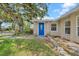Close-up view of a bright blue front door with decorative glass, flanked by stone accents and a well-maintained lawn at 3641 Coppertree Cir, Brandon, FL 33511