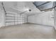 Spacious two car garage with a large door, concrete floor and white walls at 3641 Coppertree Cir, Brandon, FL 33511