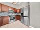 Kitchen showcasing wooden cabinets, stainless steel appliances, decorative backsplash, and tile flooring at 3641 Coppertree Cir, Brandon, FL 33511
