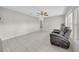Spacious living room with neutral paint, tile flooring, ceiling fan, and a comfortable gray reclining sofa at 3641 Coppertree Cir, Brandon, FL 33511
