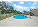 Backyard with pool, concrete pool deck, and partial fencing at 3641 Coppertree Cir, Brandon, FL 33511