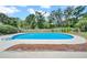 Large pool with concrete patio area, wood fence, and landscaping at 3641 Coppertree Cir, Brandon, FL 33511