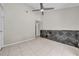 A room featuring tile floors, a statement wall, a ceiling fan, and white paint at 3641 Coppertree Cir, Brandon, FL 33511