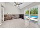 A room with tile floors, statement wall, sliding glass doors with a view of a pool at 3641 Coppertree Cir, Brandon, FL 33511