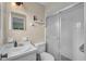 Clean, white bathroom featuring a shower with a sliding door, a vanity, and a toilet at 3849 Hollow Oak Pl, Land O Lakes, FL 34639