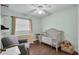 Bright bedroom with wood floors and a bassinet at 3849 Hollow Oak Pl, Land O Lakes, FL 34639