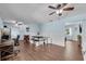 Open-concept dining area with hardwood floors and a stylish dining table, perfect for gatherings at 3849 Hollow Oak Pl, Land O Lakes, FL 34639