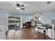 Bright dining area with sliding glass doors to pool, adjacent to an office nook at 3849 Hollow Oak Pl, Land O Lakes, FL 34639