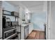 Functional kitchen featuring ample counter space, modern appliances, and convenient storage shelves at 3849 Hollow Oak Pl, Land O Lakes, FL 34639