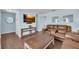 Comfortable living room showcasing hardwood floors, a large TV, and relaxed seating arrangement at 3849 Hollow Oak Pl, Land O Lakes, FL 34639