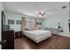 Main bedroom with a ceiling fan, hardwood floors, and a closet at 3849 Hollow Oak Pl, Land O Lakes, FL 34639