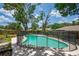 Backyard pool is surrounded by a black fence, offering a secure and enjoyable outdoor space at 3849 Hollow Oak Pl, Land O Lakes, FL 34639