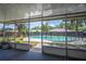 Screened porch view of a sparkling blue pool and lush backyard at 3849 Hollow Oak Pl, Land O Lakes, FL 34639
