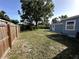 Large fenced backyard with an old, shady tree, offering a private outdoor space with great potential at 3980 55Th N Ave, St Petersburg, FL 33714