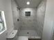 Bathroom showcasing marbled tiled shower with mosaic accent and white honeycomb shower floor at 3980 55Th N Ave, St Petersburg, FL 33714