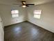 Bedroom with wood flooring, ceiling fan, and two windows offering ample natural light at 3980 55Th N Ave, St Petersburg, FL 33714