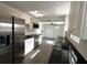Modern kitchen with stainless steel appliances, granite countertops, white cabinets, and gray wood-look flooring at 3980 55Th N Ave, St Petersburg, FL 33714