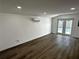 Living room featuring wood floors, recessed lights, split unit AC, and glass doors leading to backyard at 3980 55Th N Ave, St Petersburg, FL 33714