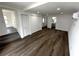 Spacious living room with wood floors, recessed lights, and access to the bathroom and entryway at 3980 55Th N Ave, St Petersburg, FL 33714