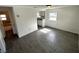 Bright, freshly painted living room with gray wood-look tile floors, ample natural light, and views to the kitchen at 3980 55Th N Ave, St Petersburg, FL 33714