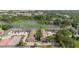 Scenic aerial view of the condo complex near the lake with parking and tennis courts at 4030 Cortez Dr # C, Tampa, FL 33614